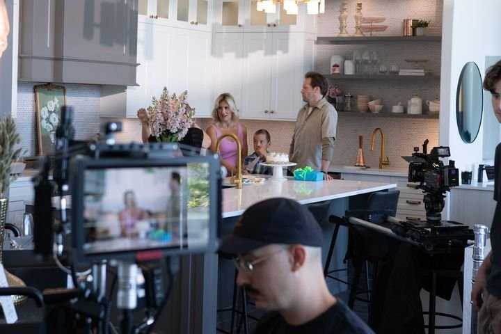 Crew filming a kitchen scene, monitor in the foreground