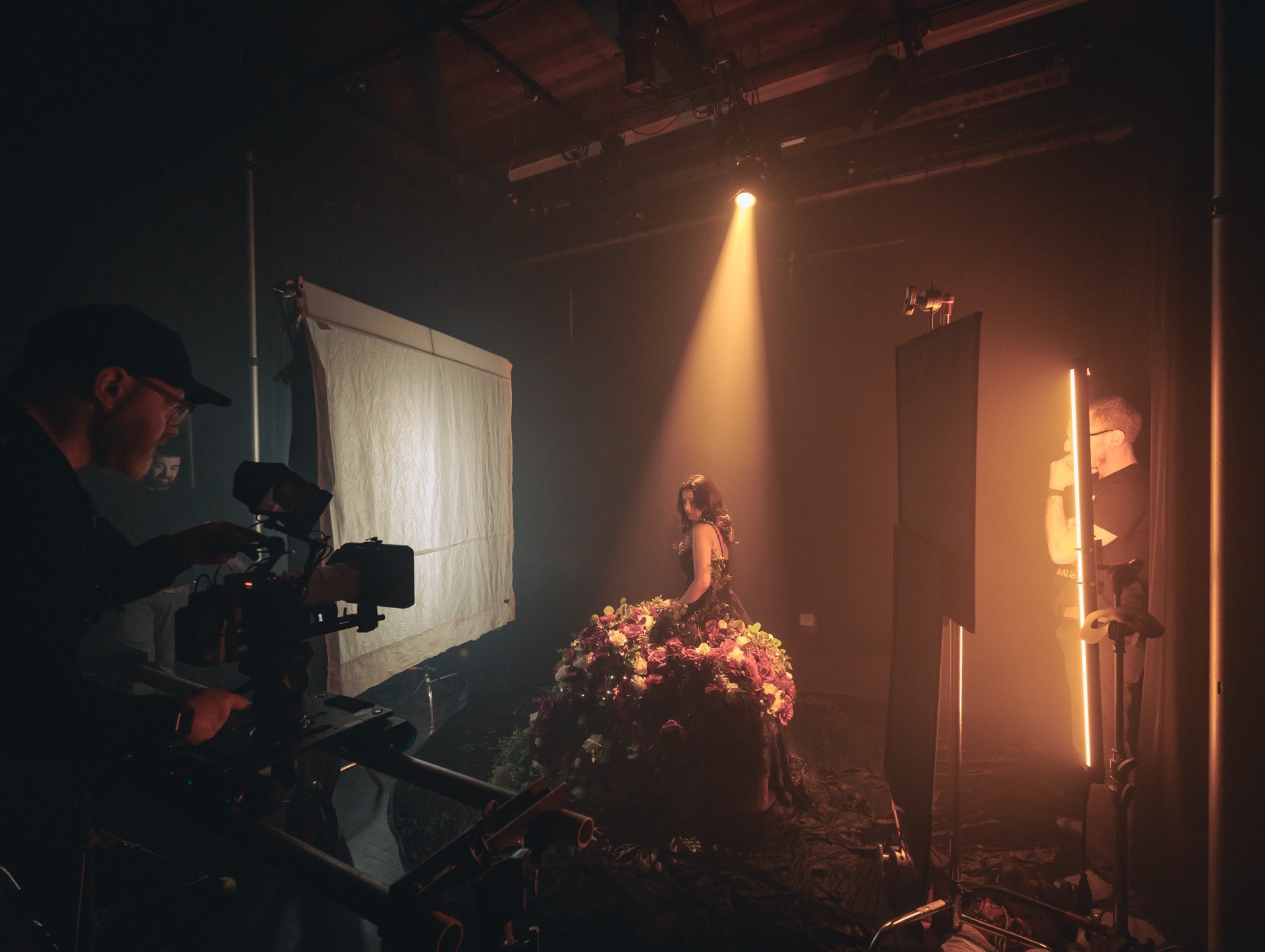 Volare Media film set in British Columbia — a lit studio scene with crew, camera and a spotlight during a music video shoot